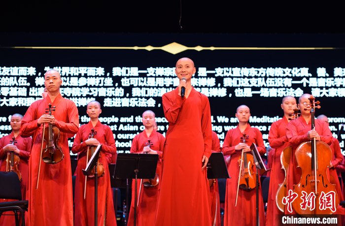 Monks dressed in orange on the scene.